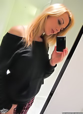 Kayden Kross poses in front of the mirror and makes pictures of herself at once.